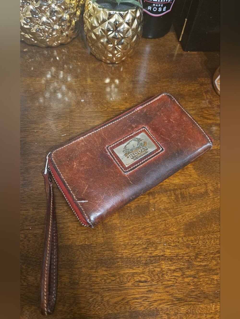 Roots Leather Zip-Around Wallet in Dark Brown with Red Trim